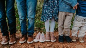 Family shoes with a missing pair of feet after a loss 