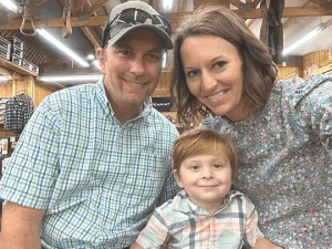 Mom, dad and toddler and smiling happily