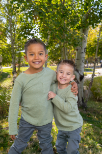 Two young brothers hug and smile after overcoming congenital heart defect 